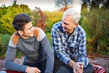 dad and teen boy talking