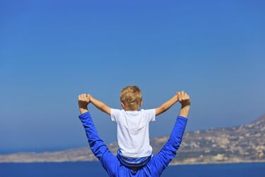 father_holding_son_arms_stretch